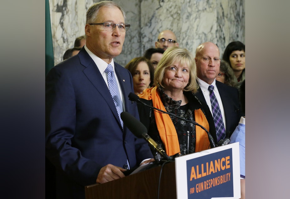 caption: Washington Gov. Jay Inslee speaks in support of firearm restrictions in 2017, as his wife, Trudi, looks on. The initiative passed, but some Washington state sheriffs are refusing to enforce all the measures.