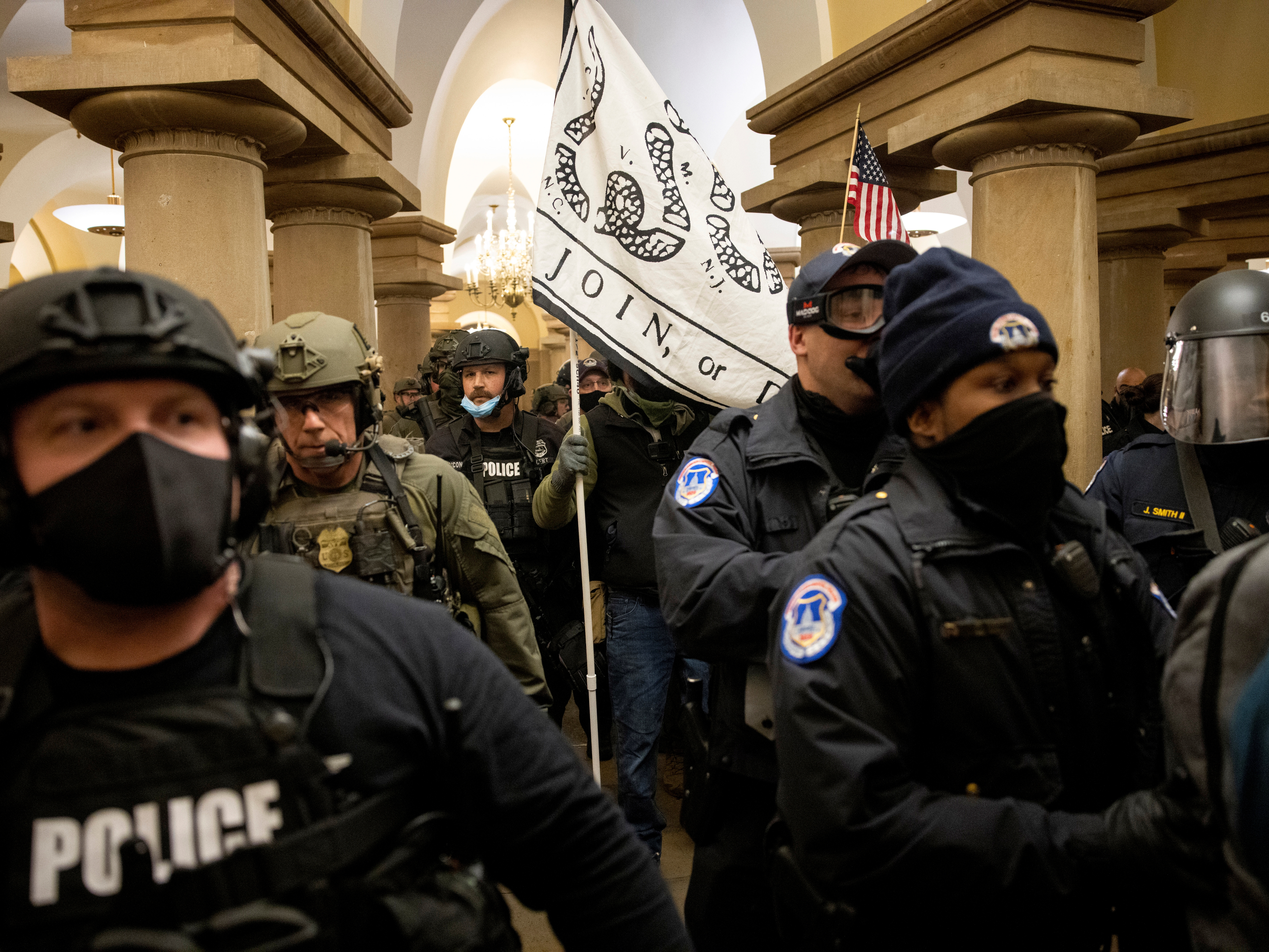 caption: FBI and ATF law enforcement push out supporters of then-President Donald Trump as they protested inside the U.S. Capitol on January 6, 2021.