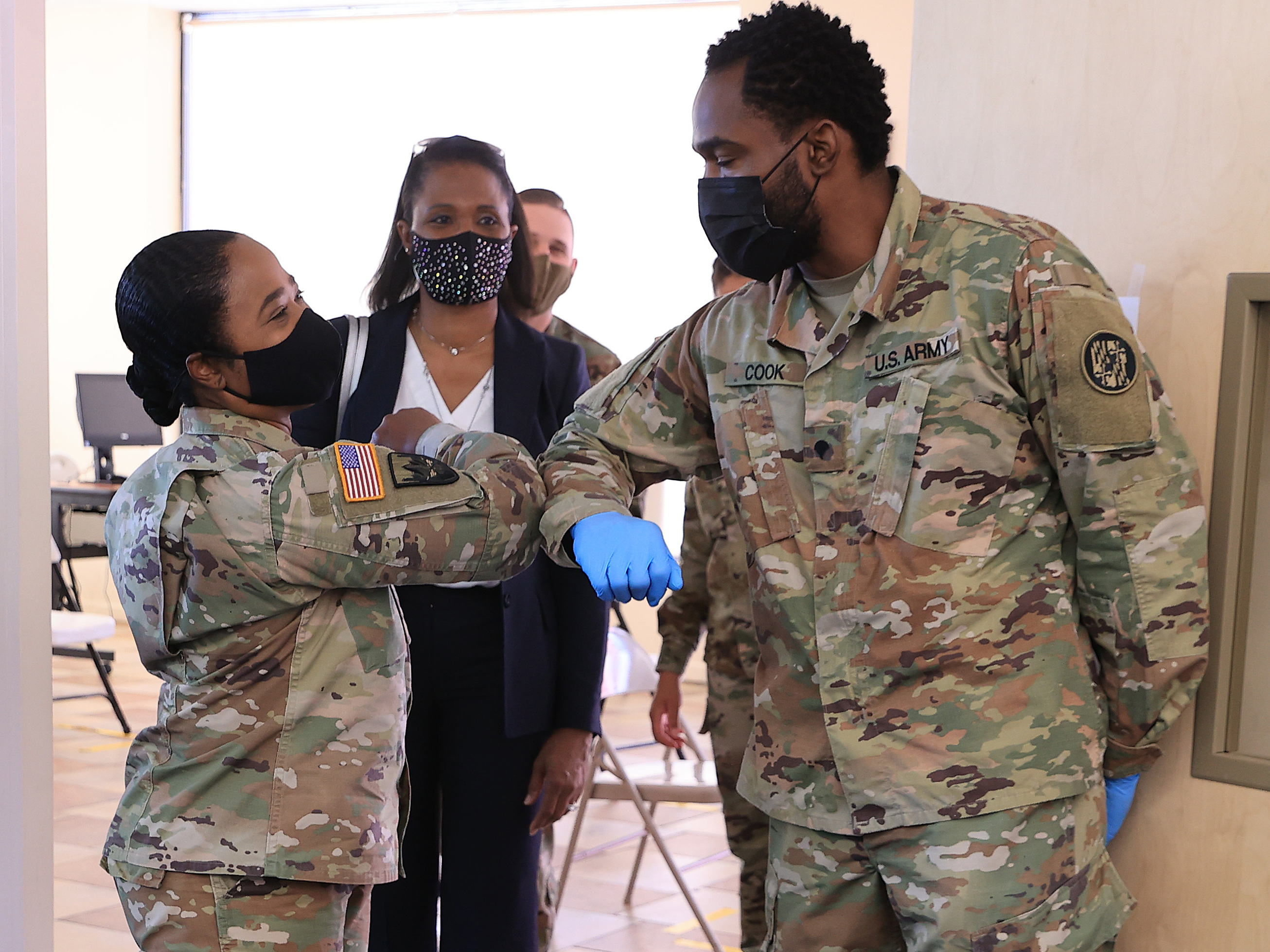 caption: Nearly 130 million U.S. adults have completed their vaccine regimens, the CDC says, with another 70 million vaccine doses currently in the distribution pipeline. Here, Maryland National Guard Brig. Gen. Janeen Birckhead greets soldiers last week at a mobile vaccine clinic in Wheaton, Md.