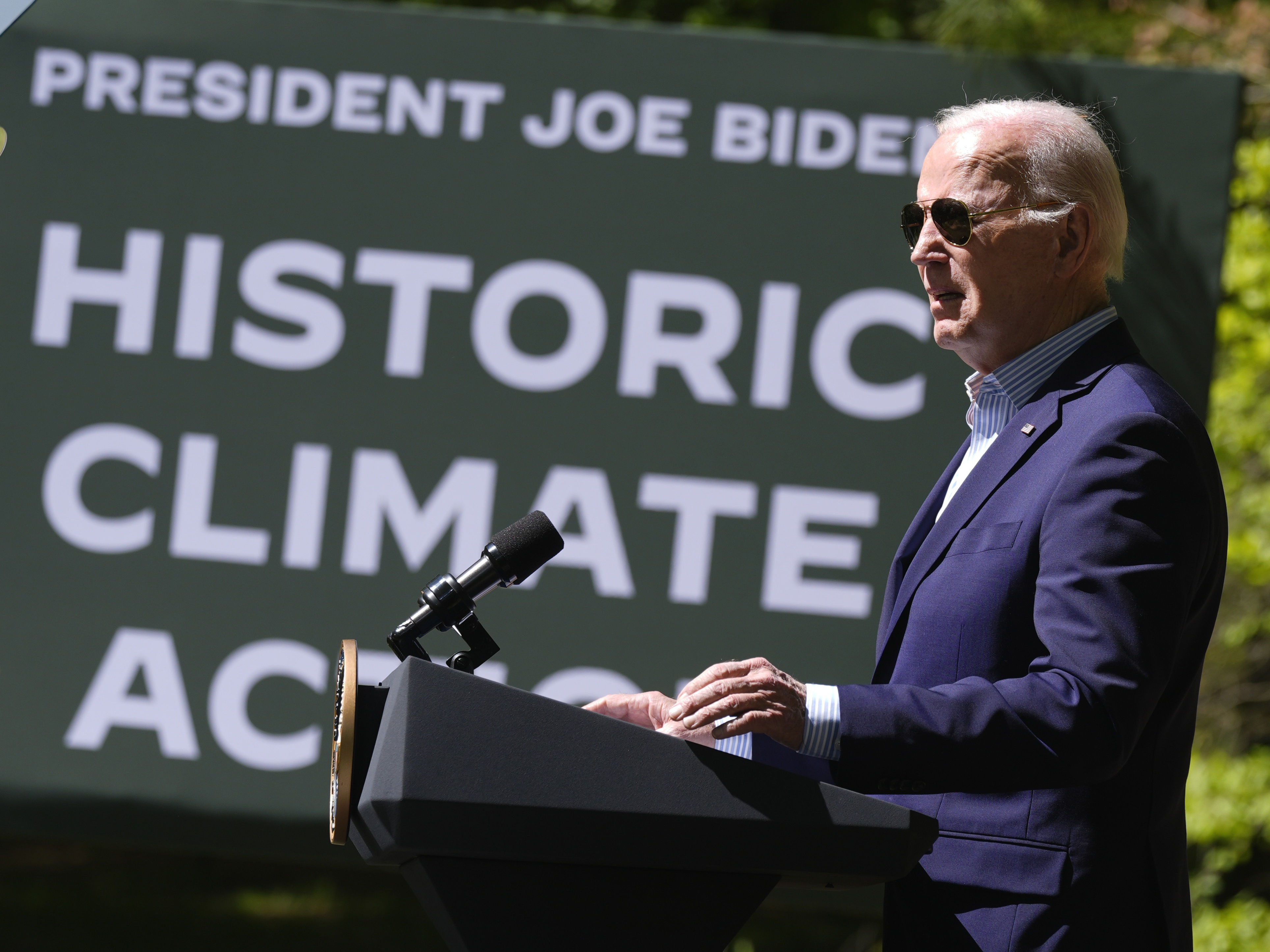 caption: President Joe Biden speaks at Prince William Forest Park on Earth Day, Monday, April 22, 2024, in Triangle, Va. Biden announced $7 billion in federal grants to provide residential solar projects serving low- and middle-income communities and an expansion of the American Climate Corps green jobs training program. 