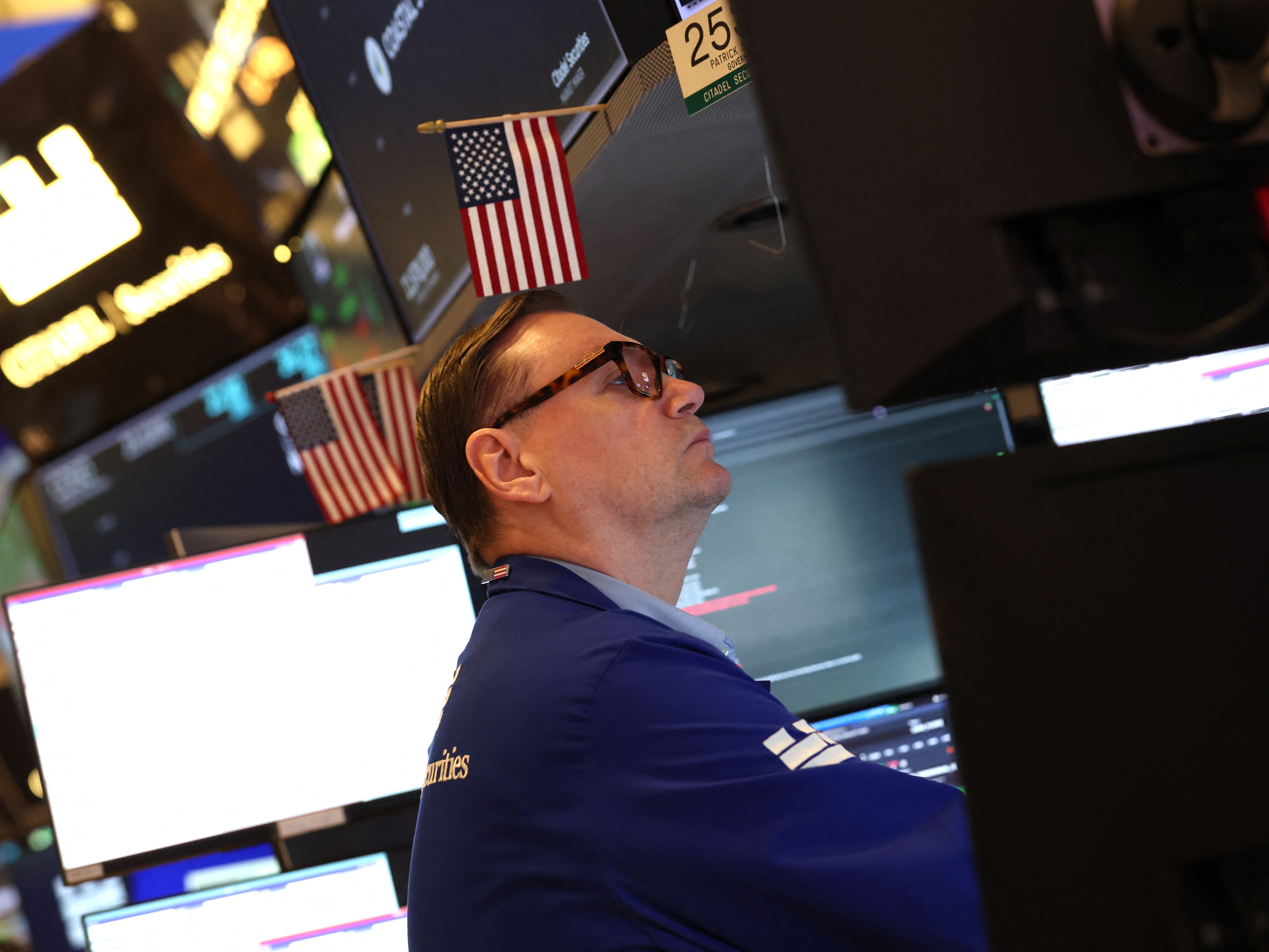caption: A trader works on the floor of the New York Stock Exchange (NYSE) after the opening bell in New York on January 7, 2026. The Dow Jones Industrial Average hit record highs on Monday and Tuesday, lifted in part by some Venezuela-related stocks.
