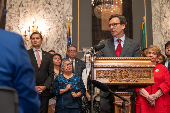 caption: Gov. Bob Ferguson speaks to press in Olympia Tuesday, Aug. 19, in response to a letter from U.S. Attorney General Pam Bondi. 