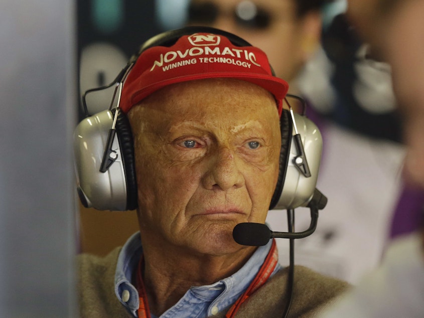 caption: Former Formula One driver Niki Lauda stands in the Mercedes pit at the Interlagos race track in Sao Paulo, Brazil, in 2017. The three-time Formula One world champion has died at the age of 70.
