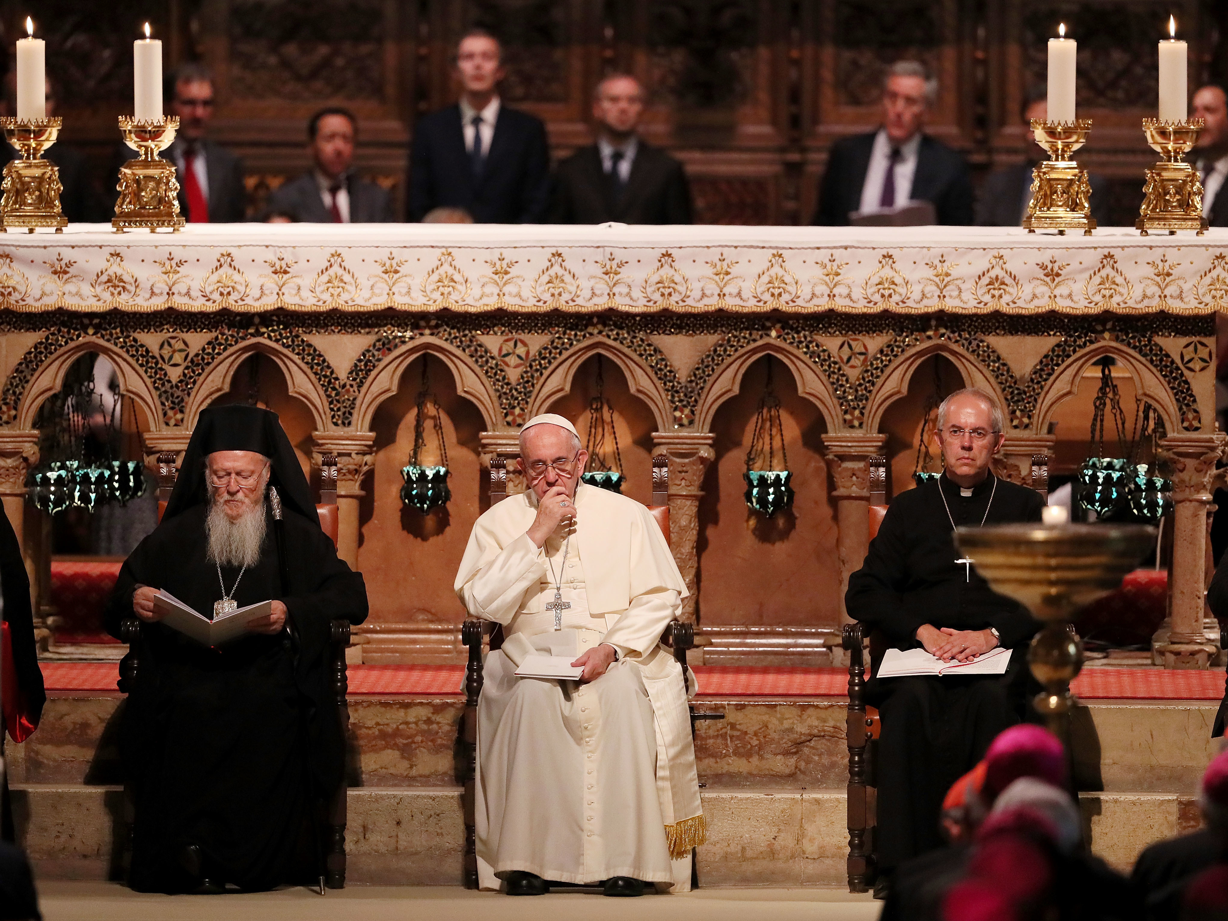 caption: Pope Francis, Archbishop of Canterbury Justin Portal Welby and Archbishop of Constantinople and Ecumenical Patriarch Bartholomew, shown at a meeting of prayer in the Basilica of St. Francis in 2016, are asking for climate action.