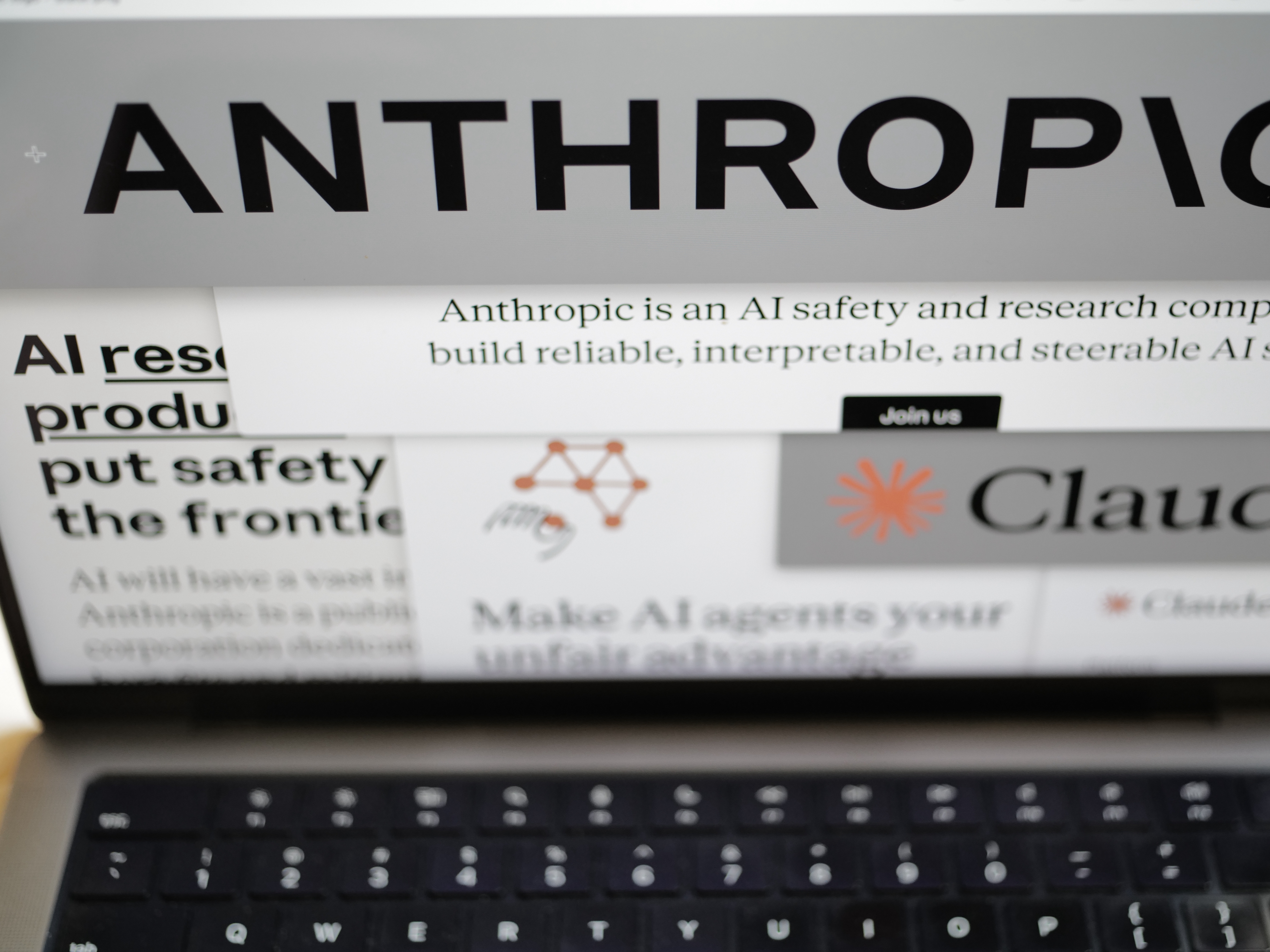 caption: Pages from the Anthropic website and the company's logos are displayed on a computer screen in New York on Thursday, Feb. 26, 2026.