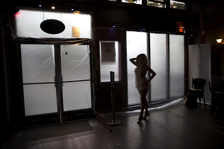 caption: Drea rehearses while looking into a mirror before a live-streamed Le Faux happy hour show next to covered windows on Wednesday, May 20, 2020, at Julia's on Broadway in Seattle.