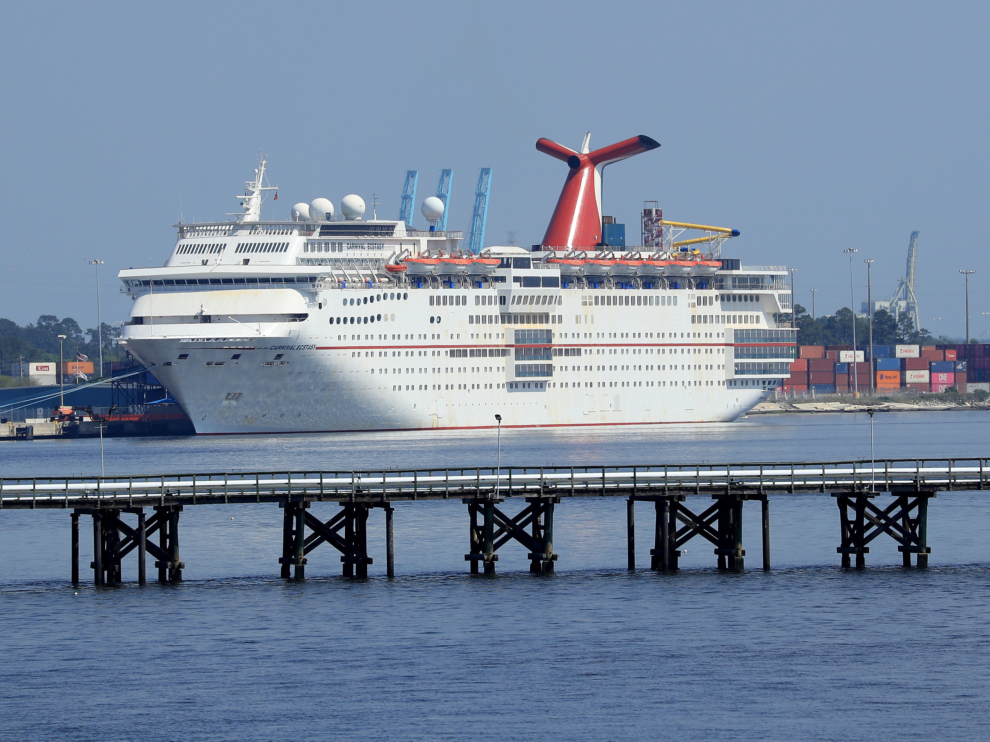 caption: Carnival Cruise Line's Ecstasy is docked amid the coronavirus outbreak on March 27 in Jacksonville, Fla. Carnival says it's planning to resume cruises beginning in August