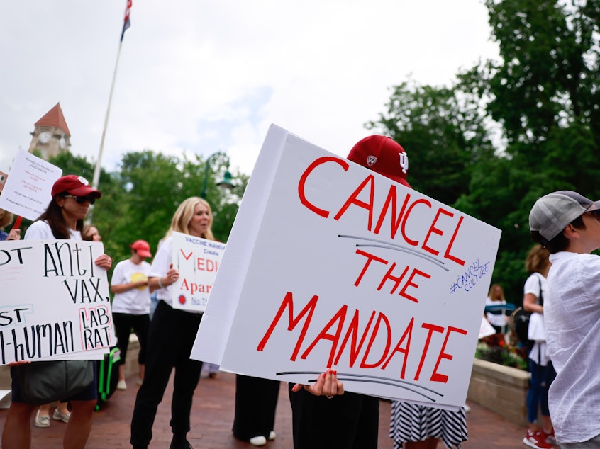 caption: In early June, people gathered on Indiana University's Bloomington campus to protest the college's vaccine requirement. Later that month, a group of students sued the school, claiming the policy violated their rights.