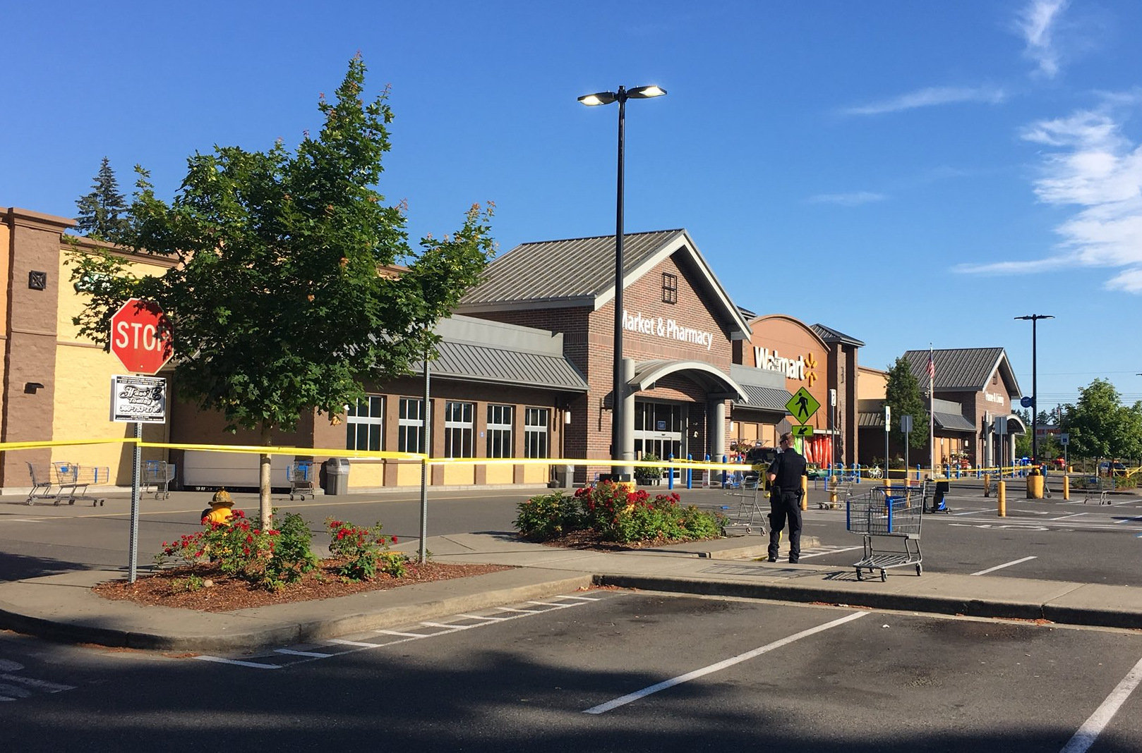 caption: Police block the scene outside a Walmart in Tumwater where a gunman shot a driver, then was himself shot to death on Sunday afternoon.