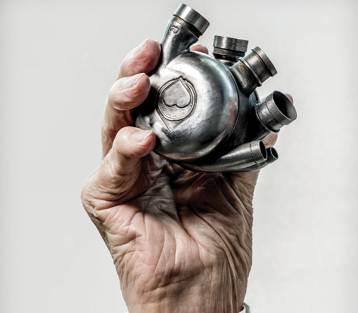 caption: Dr. Bud Frazier’s hand holding his lifelong dream, a self-contained artificial heart, the Bivacor, in 2016. (Texas Heart Institute)