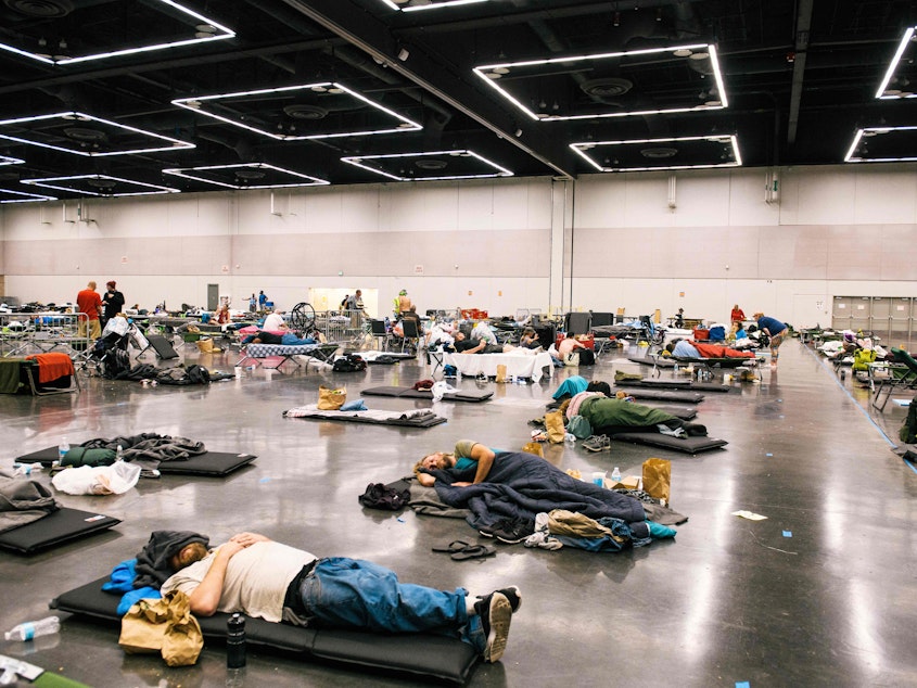 caption: People rested at the Oregon Convention Center cooling station in Portland, Oregon during a record-breaking heat wave in 2021. FEMA has never responded to an extreme heat emergency, but some hope that will change. (Photo by Kathryn Elsesser / AFP via Getty Images) 