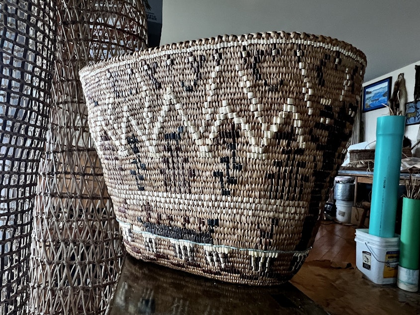 caption: An example of one of Carriere's more decorative basket weaves. Basket makers can use a variety of barks and roots for accent colors in black and white.