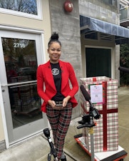 caption: KeAnna Rose Pickett, owner of The Postman, outside of the new location of The Postman on East Union Street in Seattle.