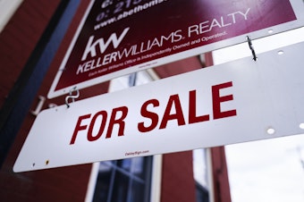 caption: A for sale sign is posted on a home last month in Philadelphia.