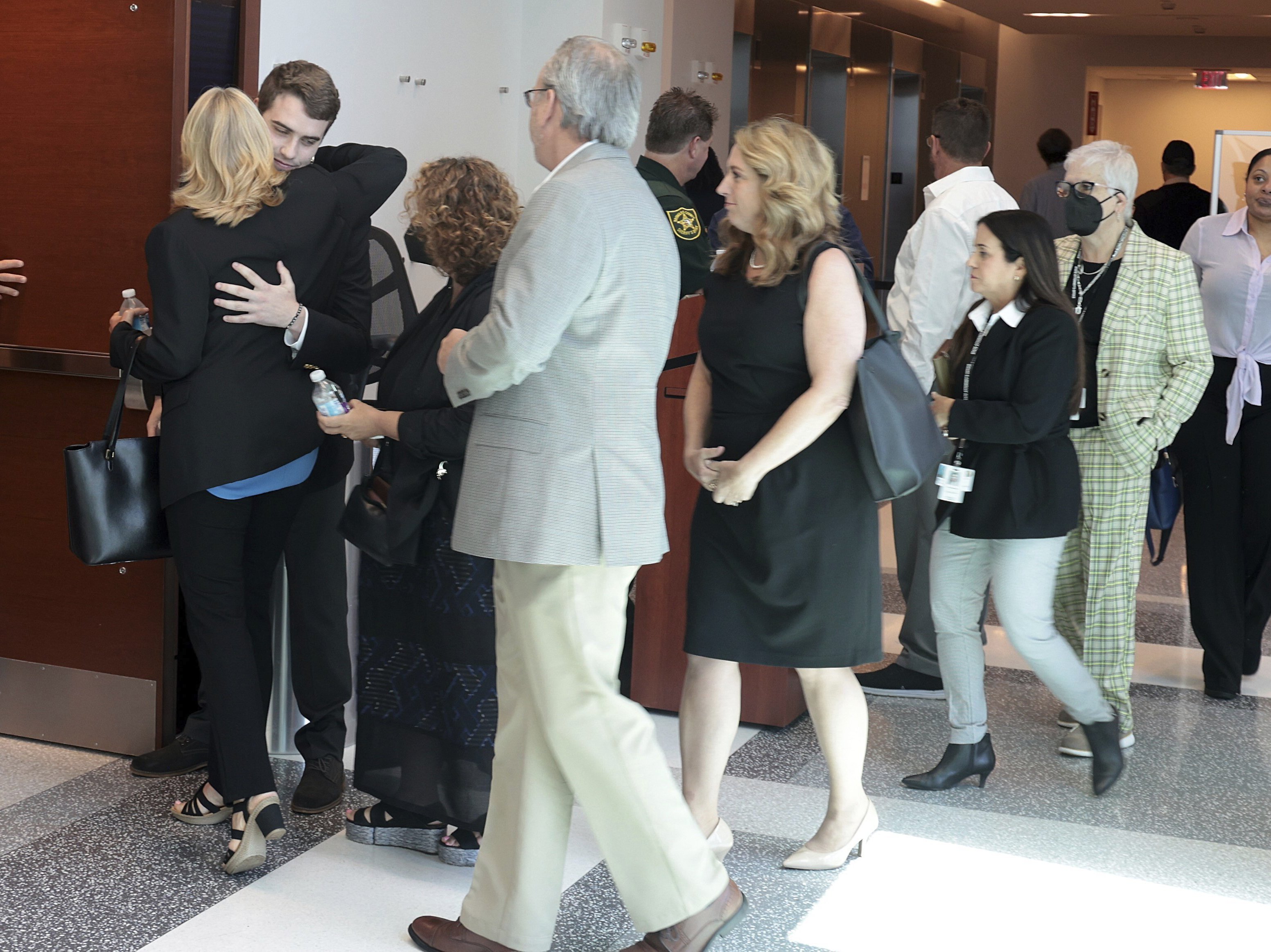 caption: Relatives and family members enter the courtroom after recess on the first day of the sentencing trial for Parkland school shooter Nikolas Cruz at the Broward County Judicial Complex on Monday in downtown Fort Lauderdale, Fla.