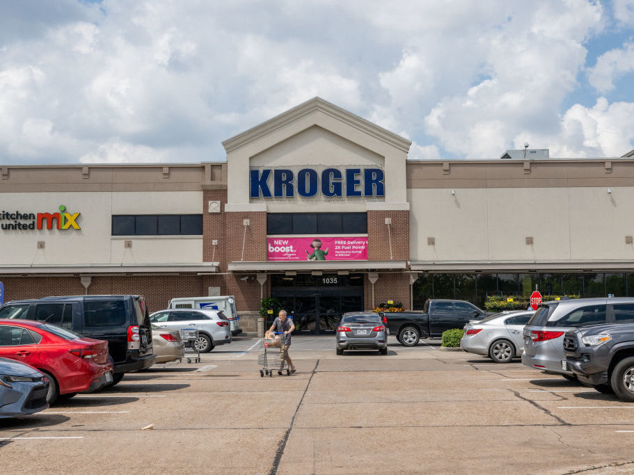 caption: A customer exits a Kroger grocery store on Sept. 9 in Houston, Tx.