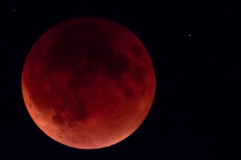 caption: The super blood moon over Seattle on Sunday, Sept. 27, 2015.