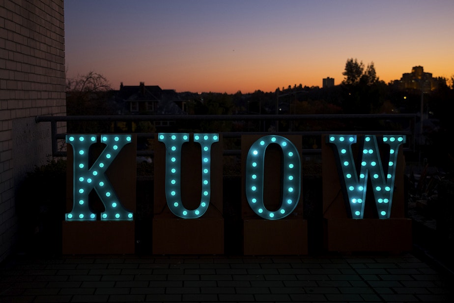 caption: KUOW letters are shown before 'That's Debatable: The Homelessness Crisis is Killing Seattle' on Tuesday, October 29, 2019, as the sun sets at Langston Hughes Performing Arts Institute in Seattle.
