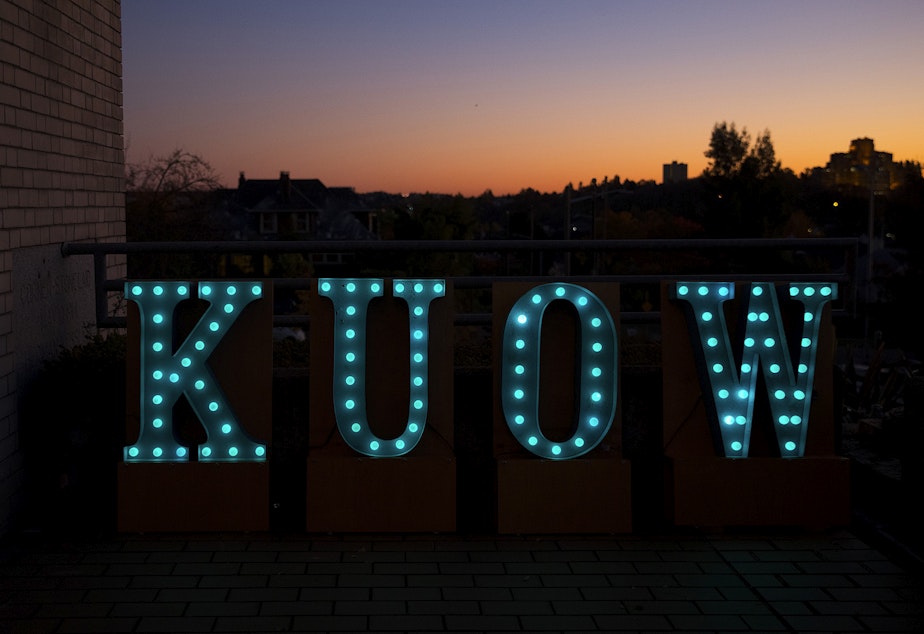 caption: KUOW letters are shown before 'That's Debatable: The Homelessness Crisis is Killing Seattle' on Tuesday, October 29, 2019, as the sun sets at Langston Hughes Performing Arts Institute in Seattle.