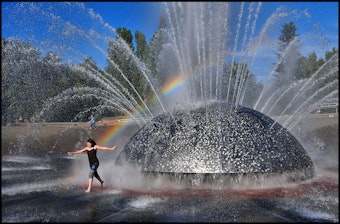 caption: Staying cool in the International Fountain at Seattle Center is one way to beat the heat.