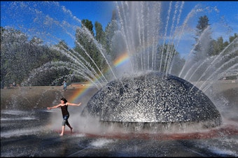 caption: Staying cool in the International Fountain at Seattle Center is one way to beat the heat.