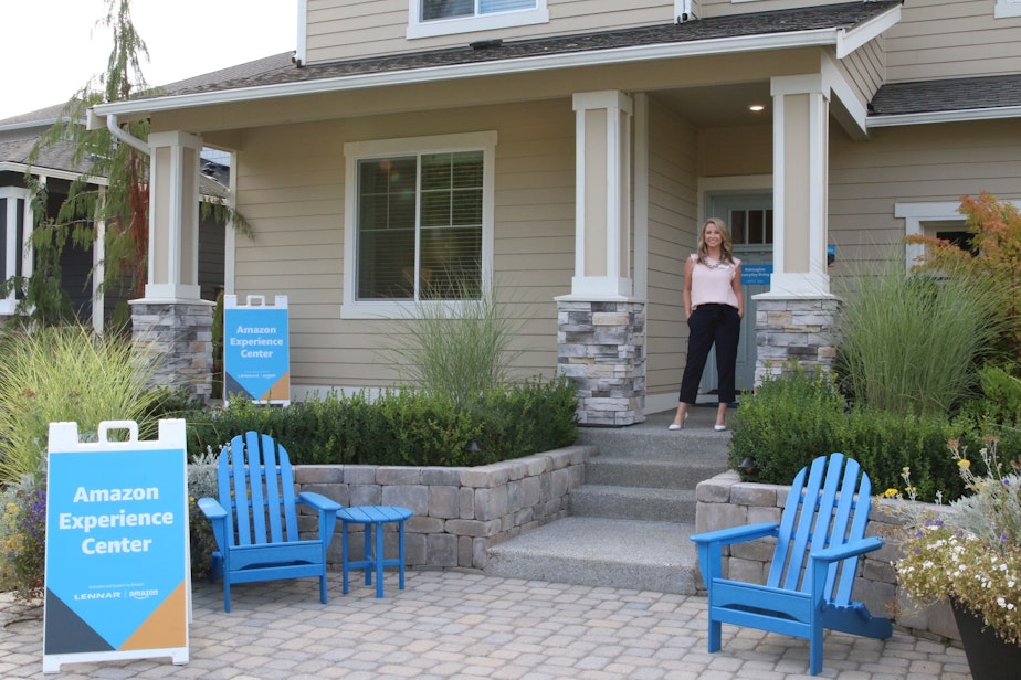 caption: Brittney Svach, a real estate agent, stands in front of an Amazon Smart Home in Black Diamond, Washington.
