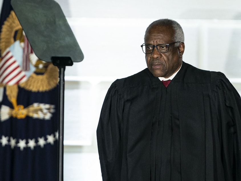 caption: Supreme Court Justice Clarence Thomas listens during a ceremony on the South Lawn of the White House in 2020.