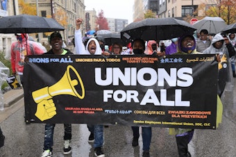 caption: Workers in Milwaukee, Wisconsin, take to the streets in Milwaukee, Wisconsin.