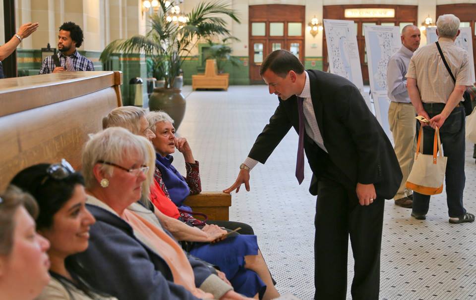 caption: Councilmember Rod Dembowski speaks with constituents about proposed transit cuts at a May 13 forum at Union Station. 