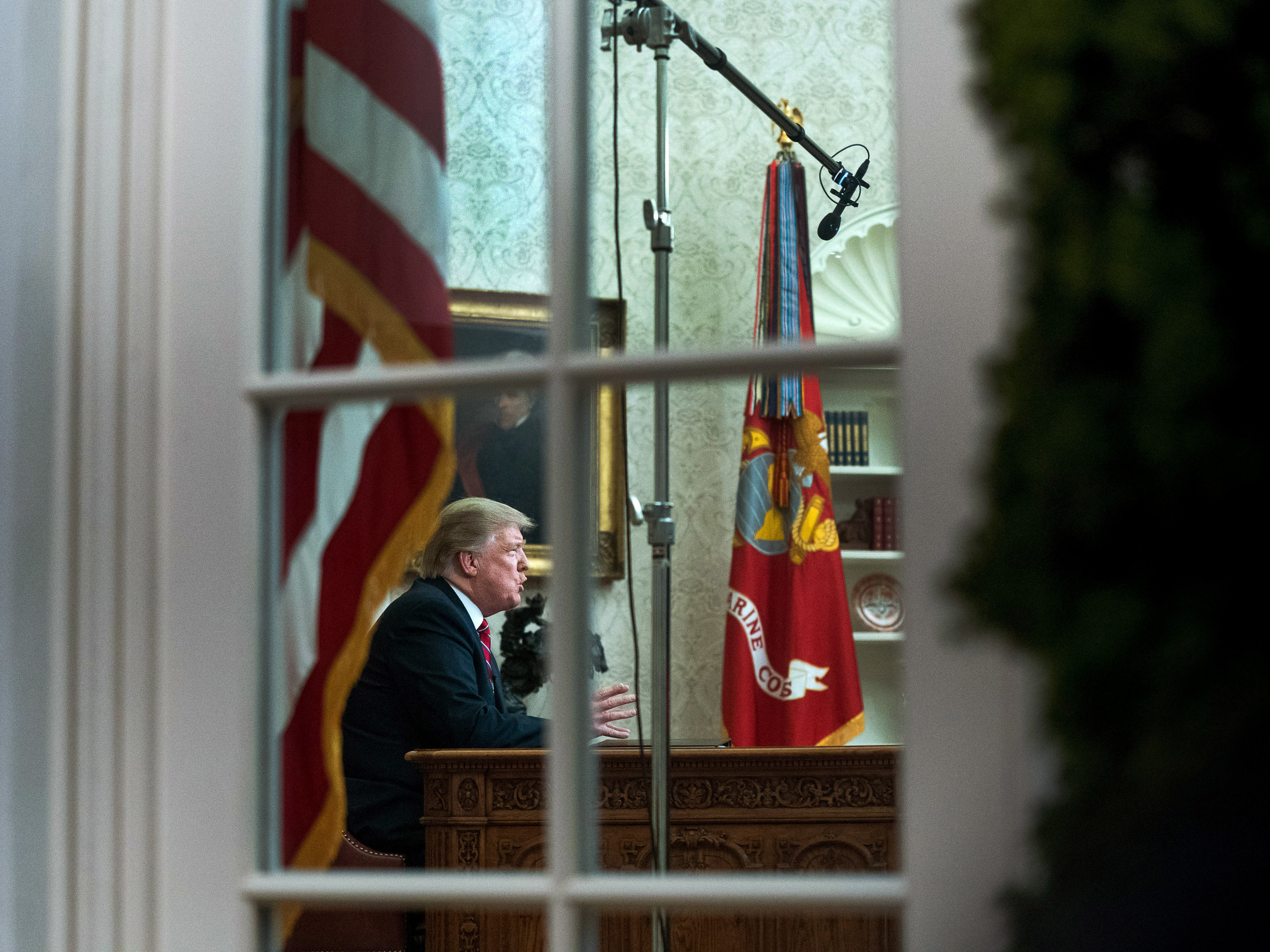 caption: President Trump speaks to the nation in his first-prime address from the Oval Office of the White House on Tuesday.