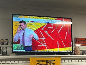 caption: Meteorologist Doug Kammerer pauses his live weather broadcast to warn his family about a tornado warning.