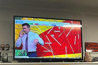 caption: Meteorologist Doug Kammerer pauses his live weather broadcast to warn his family about a tornado warning.
