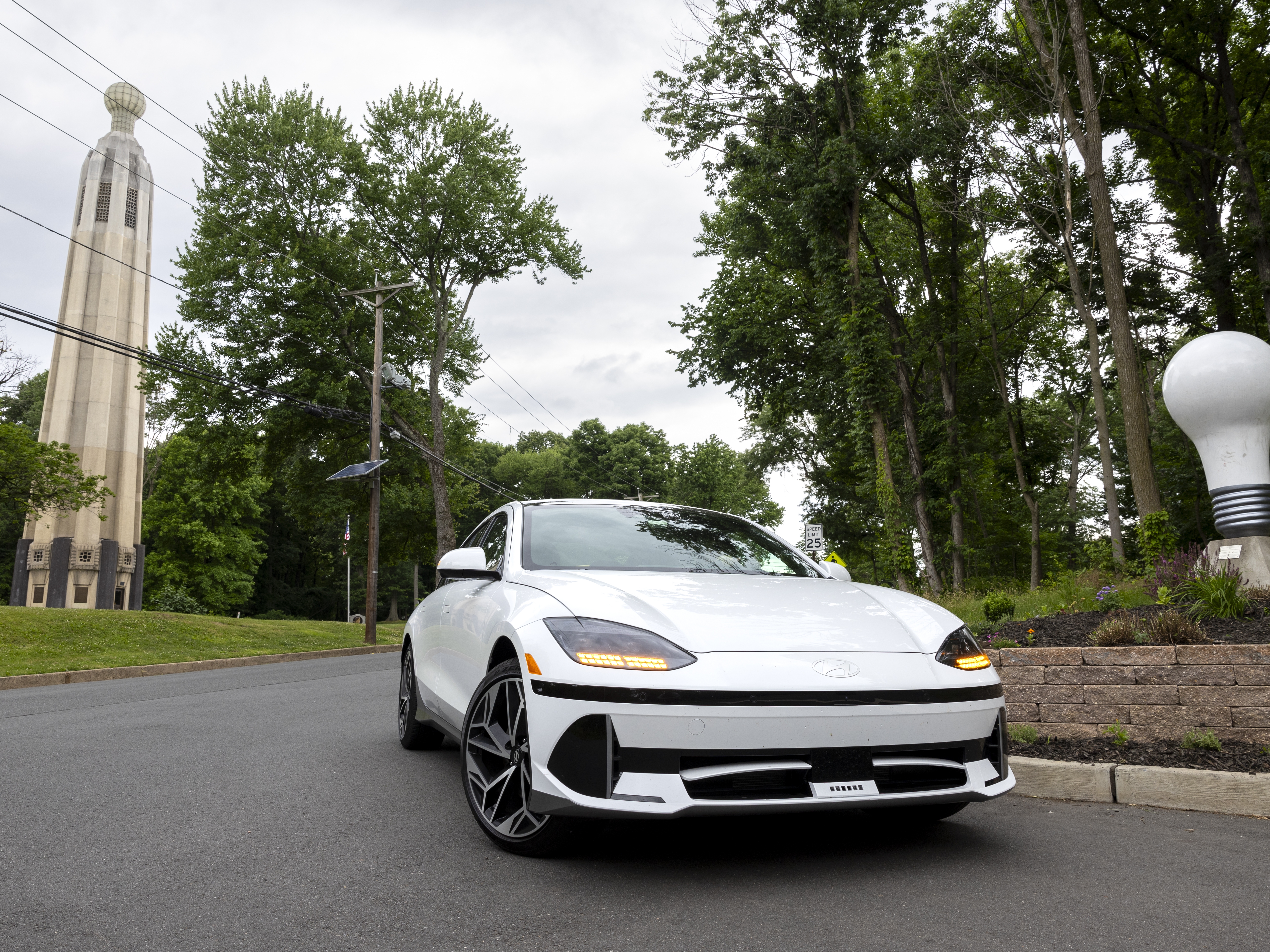 caption: Electric innovations past and present: The Hyundai Ioniq 6 that NPR took on a road trip stopped at the Thomas Edison Center at Menlo Park in Edison, N.J., on June 11. It’s the site of the world’s second-largest light bulb (that would be the one on top of the tower, at left) in honor of Thomas Edison.
