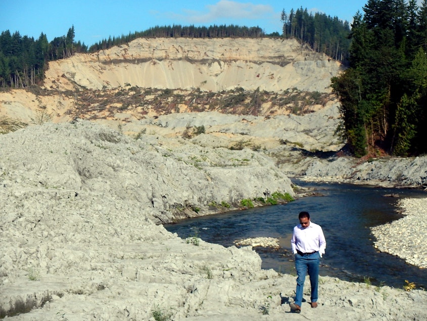 caption: SR 530 Landslide Commissioner Paul Chiles of Seattle at the Oso landslide site in August.