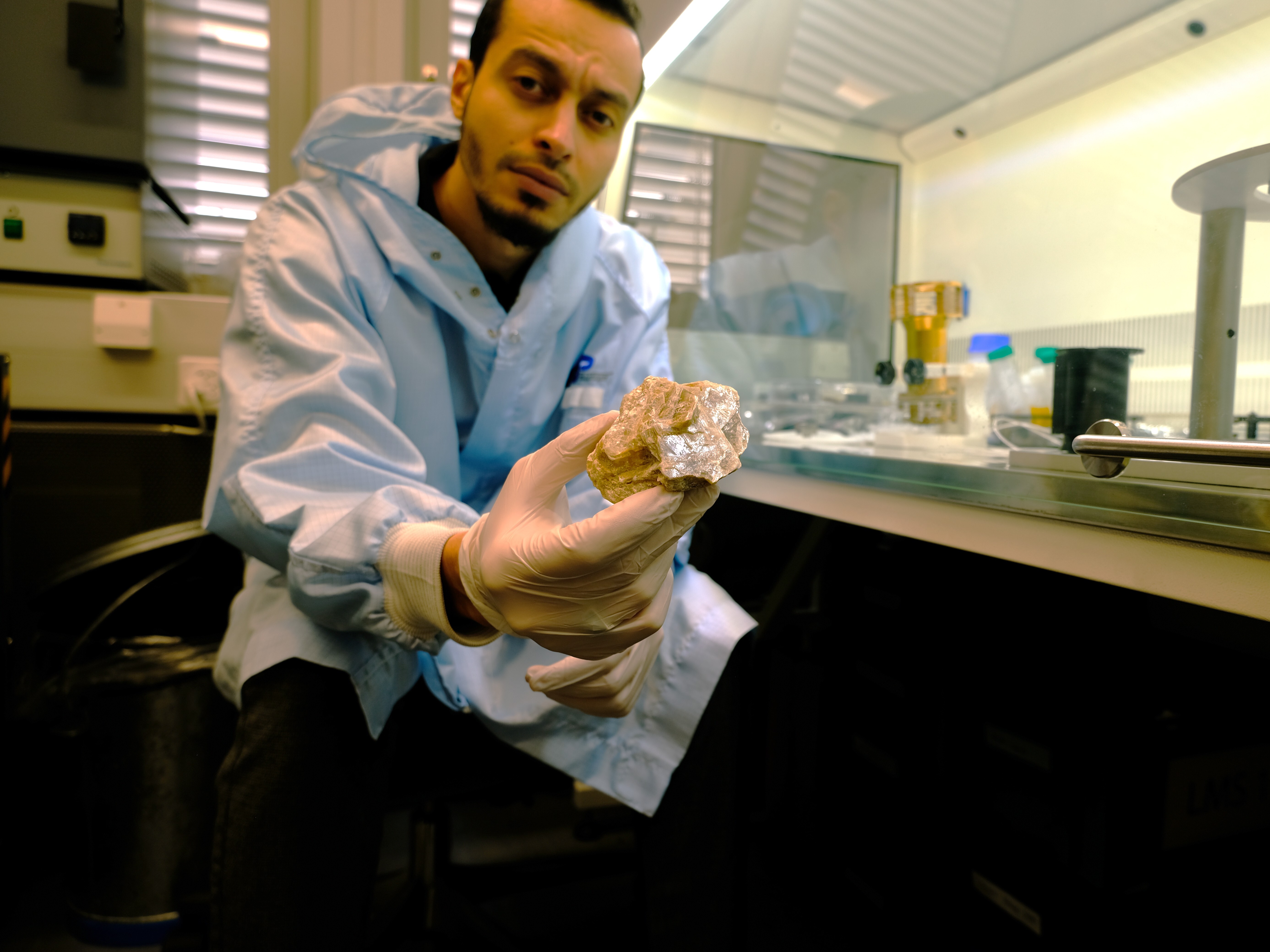 caption: Youcef Sellam in his lab with the fossil filaments found in the gypsum.