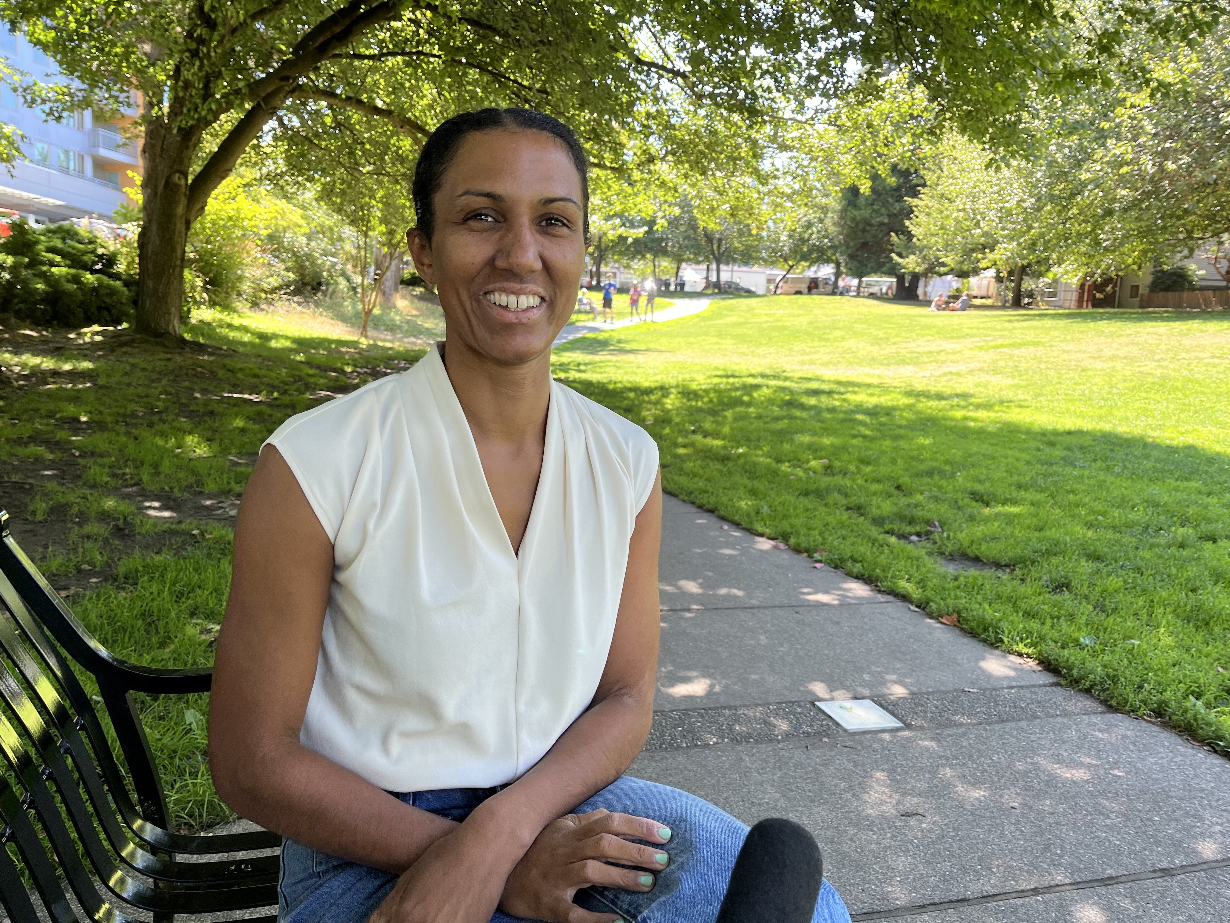 caption: Dionne Foster, candidate for Seattle City Council Position 9, in Columbia City on Aug. 20, 2025. 