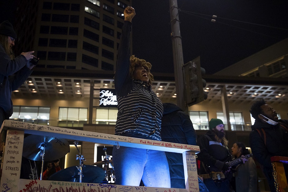 caption: Vonn Wright, also known as Fairy Vonn Mother, cheers as  Marshall Law Band plays a song from their new album, 12th and Pine, for the crowd on Monday, October 26, 2020, during the 150th day of protests for racial justice in Seattle at Westlake Park. The album was inspired by Seattle's ongoing protests for racial justice. 