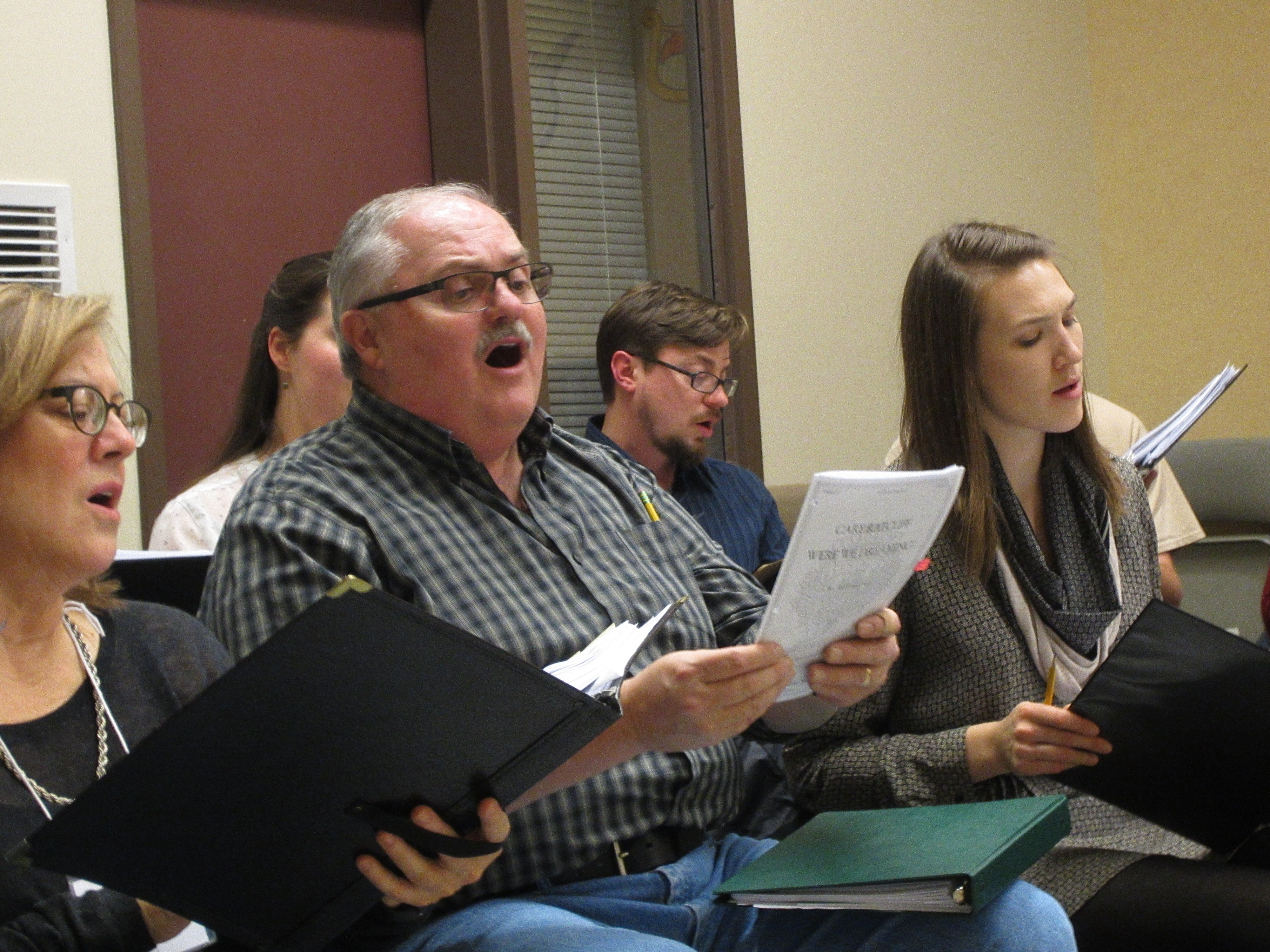 caption: Tenor Marty Mullin (center) at Cantare Vocal Ensemble rehearsal.