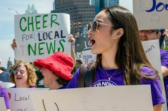 caption: Journalists protest outside the offices of the <em>Austin American Statesman</em> in June as part of a nationwide effort by staff at Gannett-owned newspapers to draw attention to layoffs and budget cuts. A coalition of donors is promising to bolster local news with a half-billion dollars over five years.