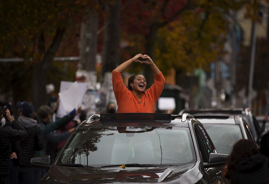 caption: An impromptu car parade and celebration took place shortly after Joe Biden was officially named the president elect on Saturday, November 7, 2020, near the intersection of 10th Avenue and East Pine Street in Seattle.