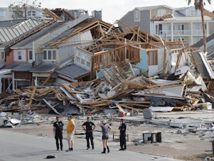 caption: Rescue personnel search for people who may need help in Mexico Beach, Fla., on Thursday, one day after Hurricane Michael made landfall near the area.