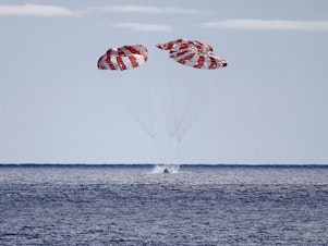 caption: NASA's Orion Capsule splashes down after a successful uncrewed Artemis I Moon Mission on Sunday, seen from aboard the USS Portland in the Pacific Ocean off the coast of Baja California, Mexico.