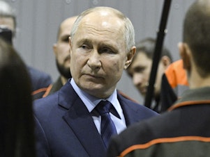 caption: Russian President Vladimir Putin visits a factory on Thursday.
