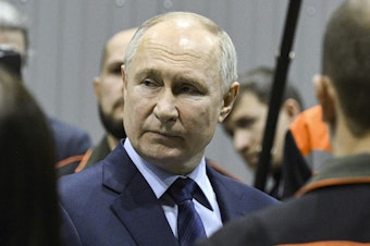caption: Russian President Vladimir Putin visits a factory on Thursday.