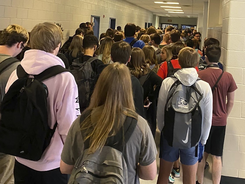 caption: In a photo posted on Twitter last week, students crowd a hallway at North Paulding High School in Dallas, Ga. Dozens of students in another suburban Atlanta school district have now tested positive for the coronavirus, forcing hundreds to be quarantined as a precaution.
