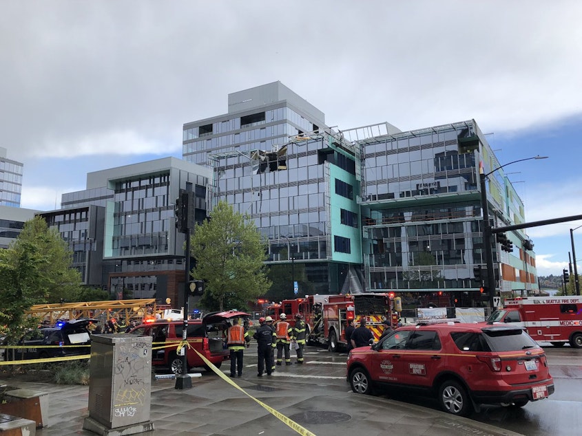 caption: The scene an hour after a crane collapsed on a building at the corner of Fairview and Mercer in downtown Seattle, leaving four dead and three wounded. Among those wounded was a mother and child. 