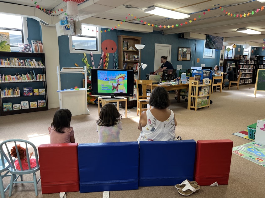 caption: Kids and caretakers watch a "Madeline" DVD in the basement of the Columbia County Library on a hot Tuesday afternoon.
