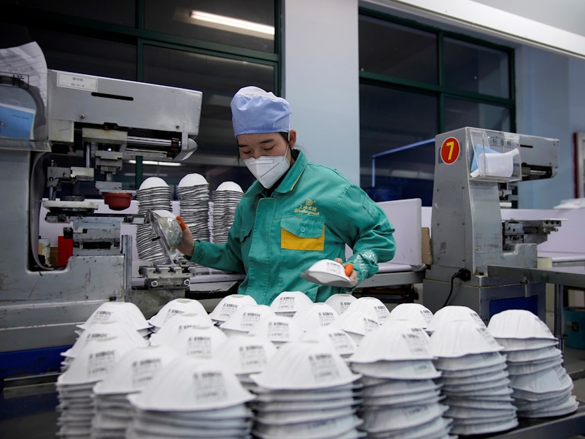 caption: A production line for the manufacture of masks at a factory in Shanghai, China.