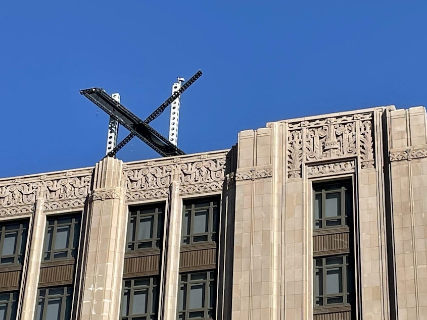 caption: The new X sign is installed Friday on the roof of the San Francisco headquarters of Twitter, which is being rebranded as "X." Elon Musk killed off the Twitter logo on Monday, replacing the world-recognized blue bird with an X as the tycoon accelerates his efforts to transform the floundering social media giant.