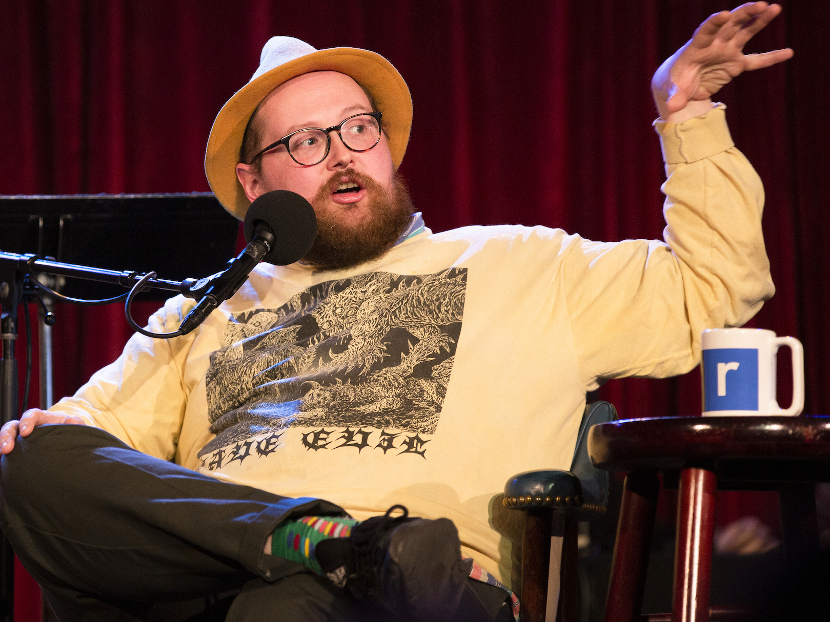 caption: Dan Deacon plays a game with Ophira Eisenberg on <em>Ask Me Another</em> at the Bell House in Brooklyn, New York.